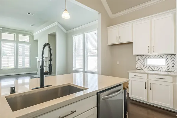a kitchen with a sink and cabinets