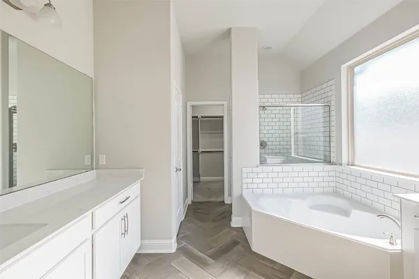 a bathroom with a bathtub and a sink