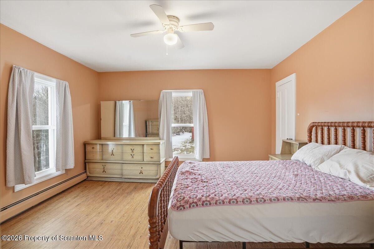 795 Wescott Road New Milford, PA 18834 - Photo 47 of 81 a bedroom with a large bed and a chandelier