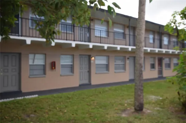 a view of a house with a yard and plants