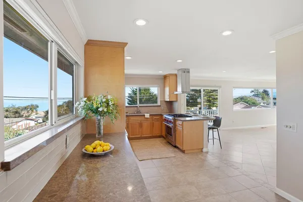 a kitchen with stainless steel appliances granite countertop a stove a sink and a refrigerator