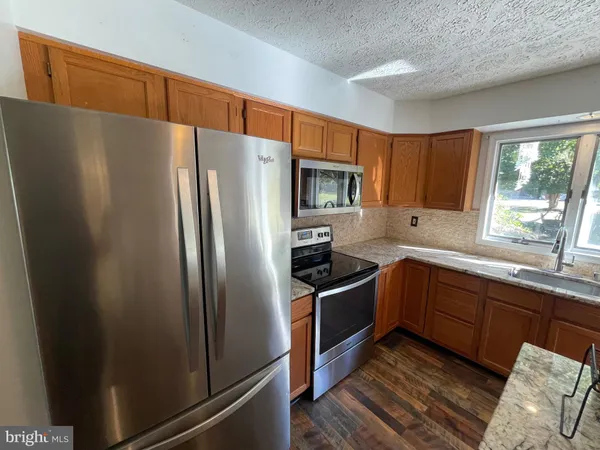 a kitchen with granite countertop lots of counter top space and stainless steel appliances