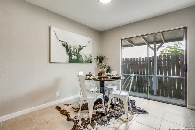 a view of a dining room with furniture and front door