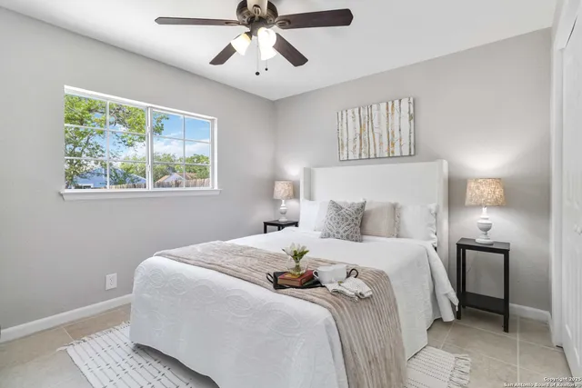 a bedroom with a large bed and a chandelier