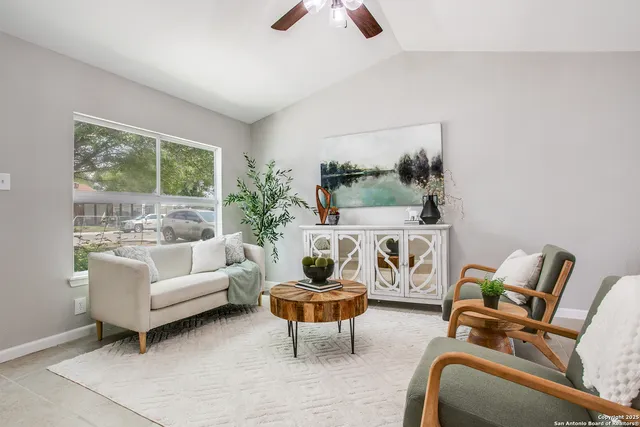 a living room with furniture and a large window