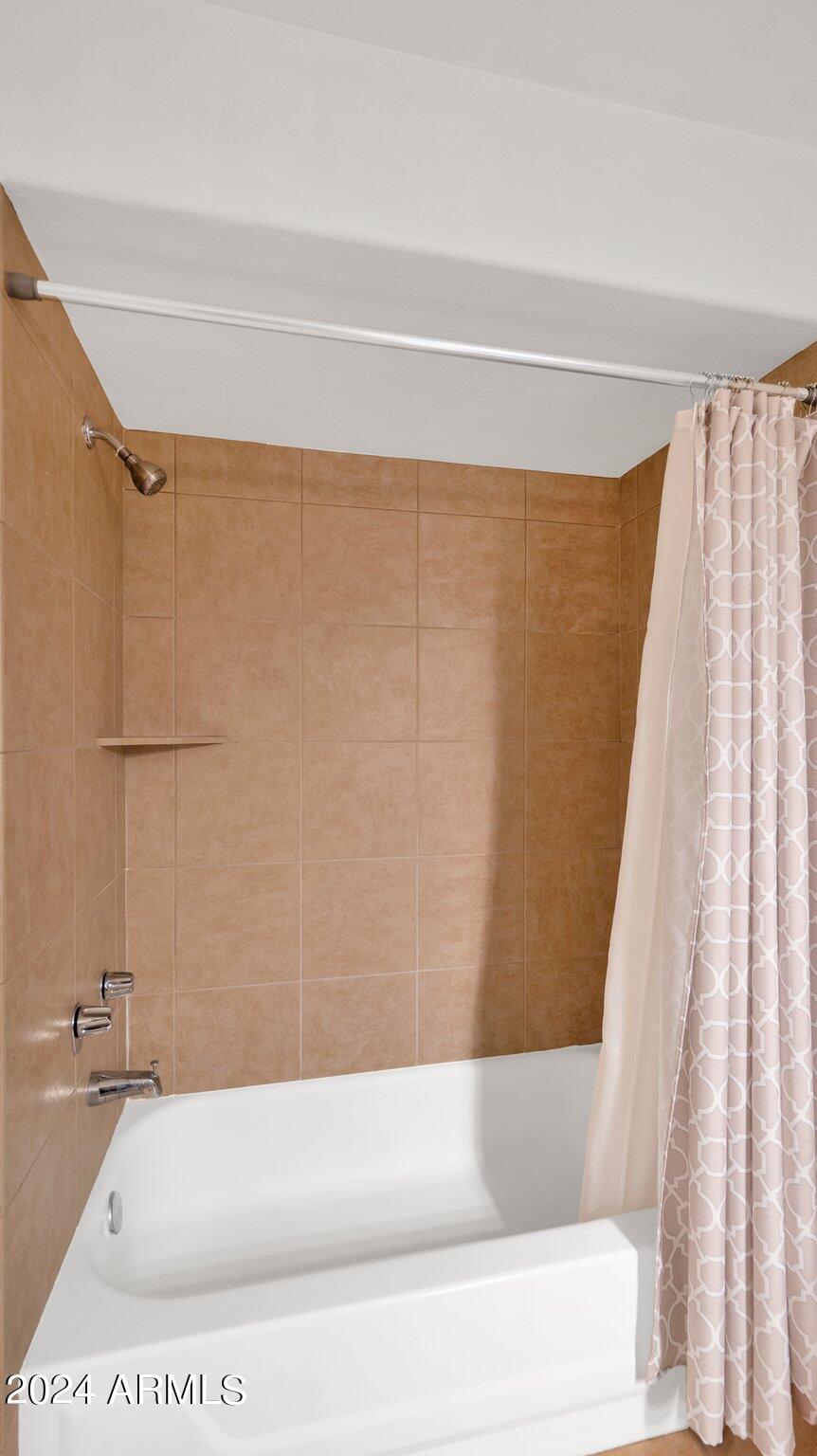 9990 North Scottsdale Road, Unit 1019 Paradise Valley, AZ 85253 - Photo 24 of 30 a bathroom with a bathtub and a shower