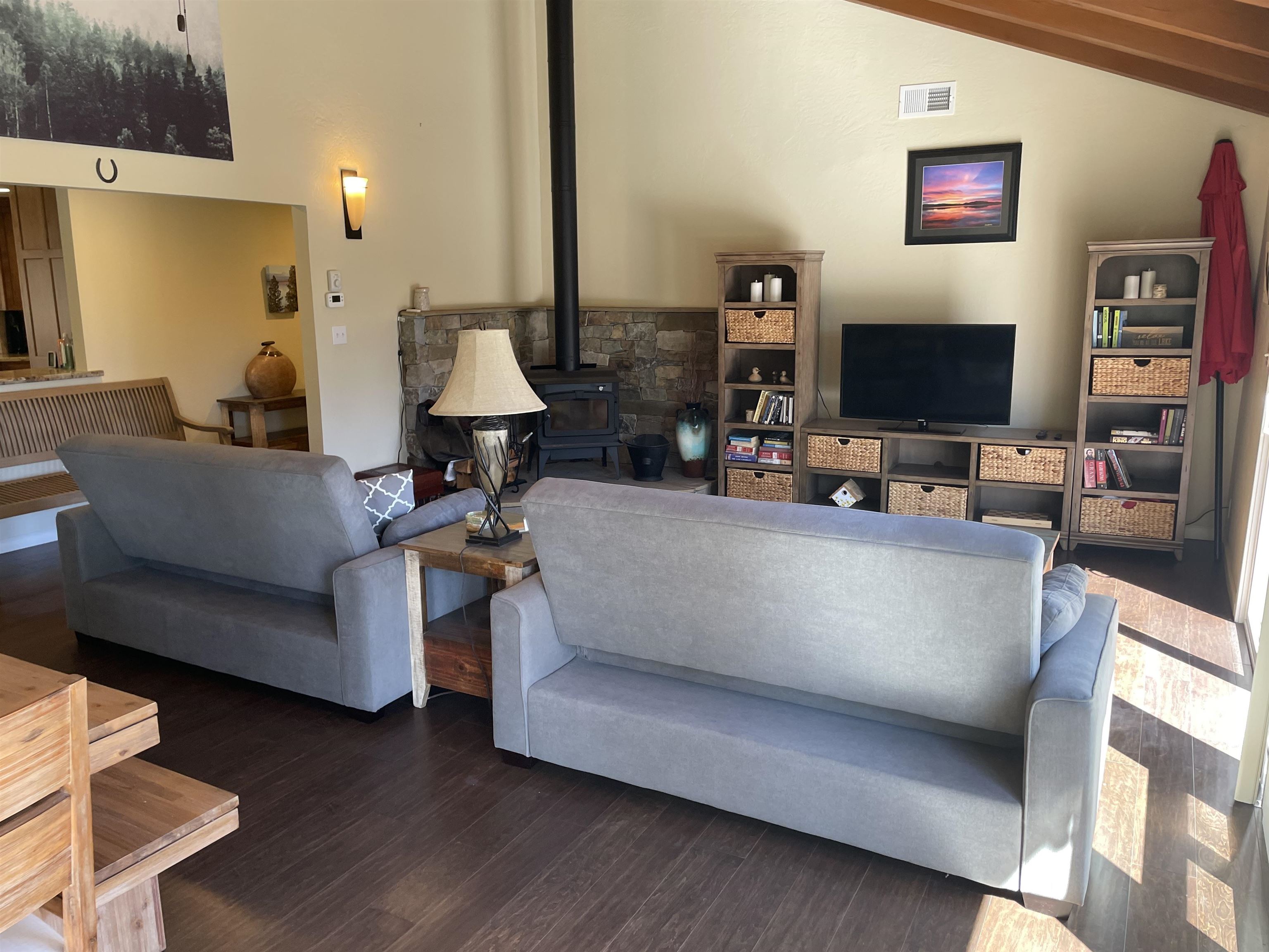 831 Timber Ridge Road Lake Almanor, CA 96137 - Photo 8 of 36 a living room with furniture and a flat screen tv