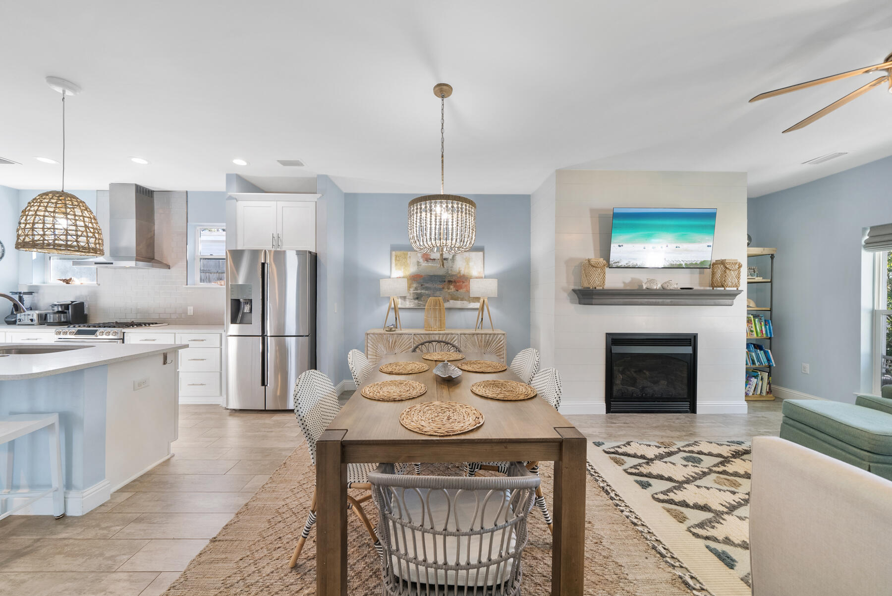 115 Barcelona Avenue Santa Rosa Beach, FL 32459 - Photo 2 of 34 a kitchen with stainless steel appliances a stove a refrigerator and a fireplace