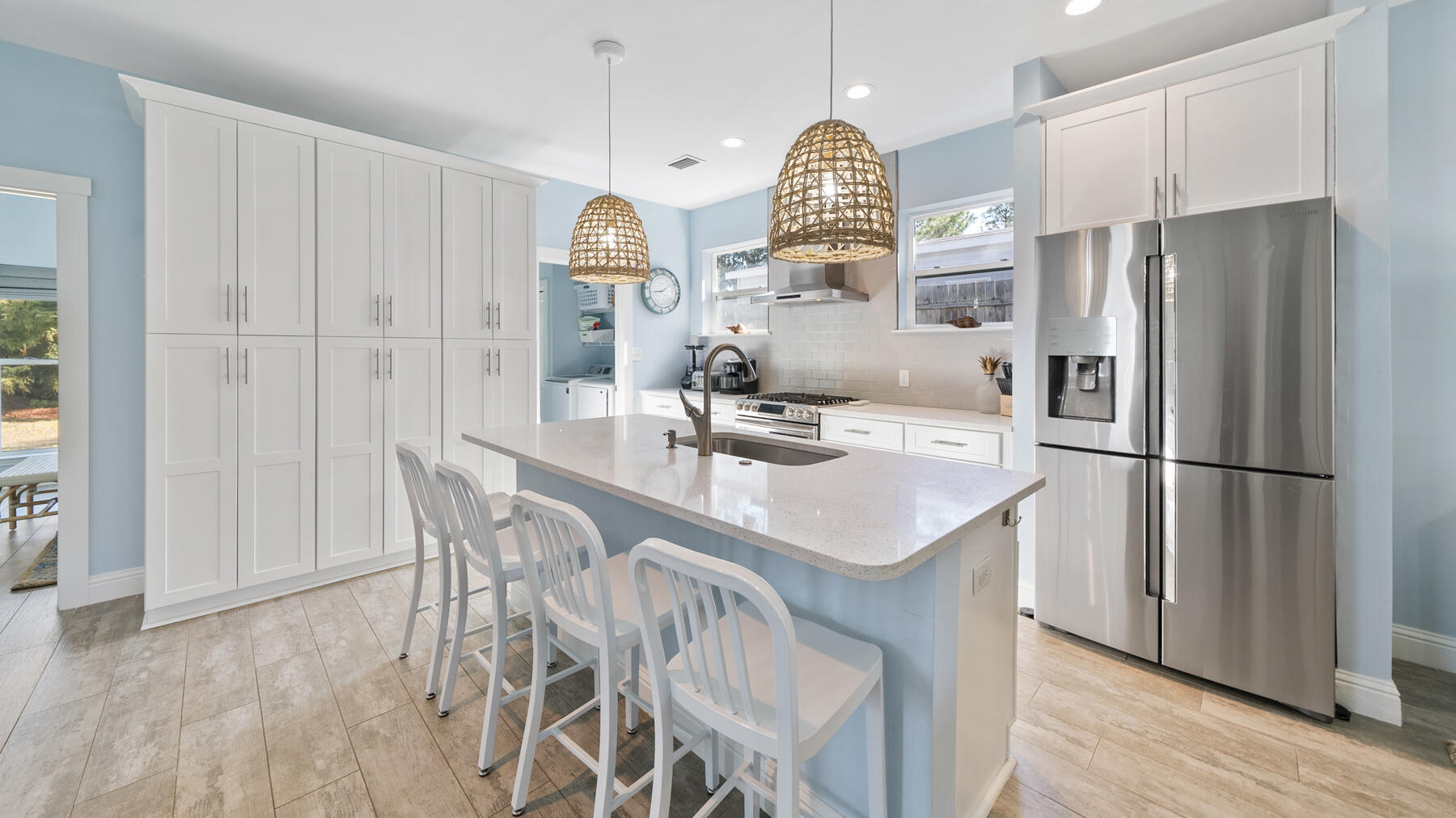 115 Barcelona Avenue Santa Rosa Beach, FL 32459 - Photo 6 of 34 a kitchen with stainless steel appliances a dining table chairs and wooden floor