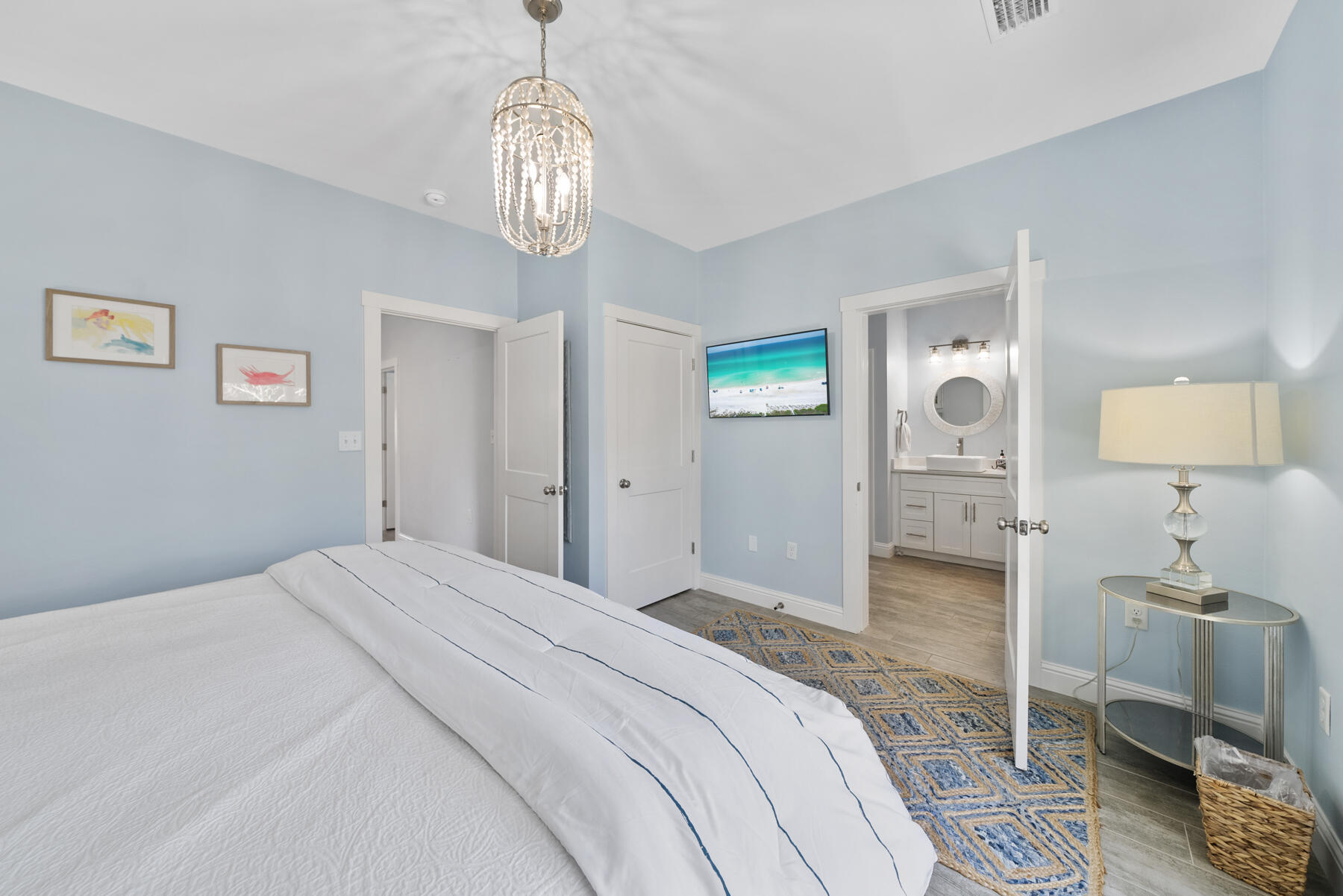 115 Barcelona Avenue Santa Rosa Beach, FL 32459 - Photo 10 of 34 a bedroom with a bed and a chandelier