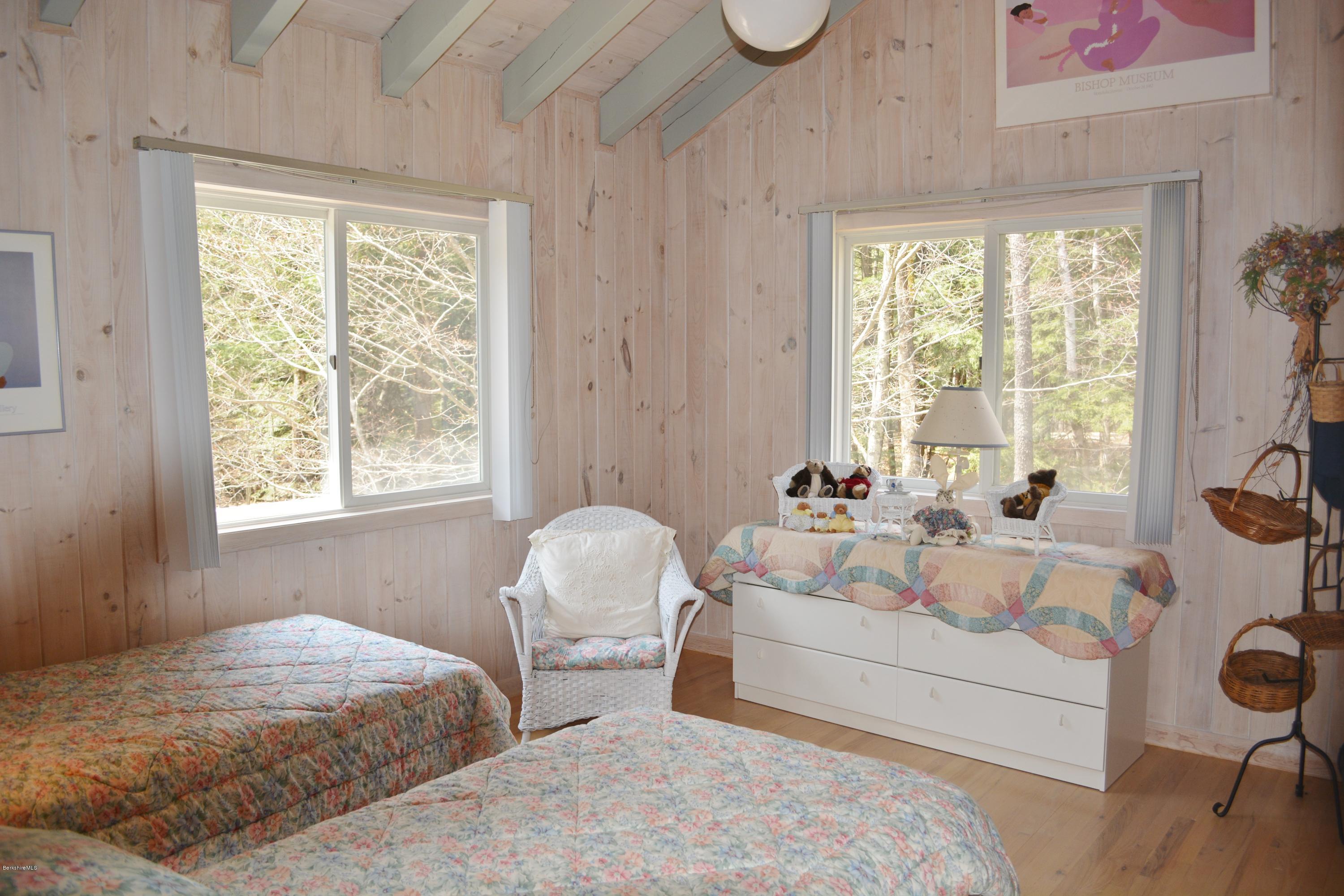 7 Sioux Road Becket, MA 01223 - Photo 12 of 22 a bedroom with a bed and a large window