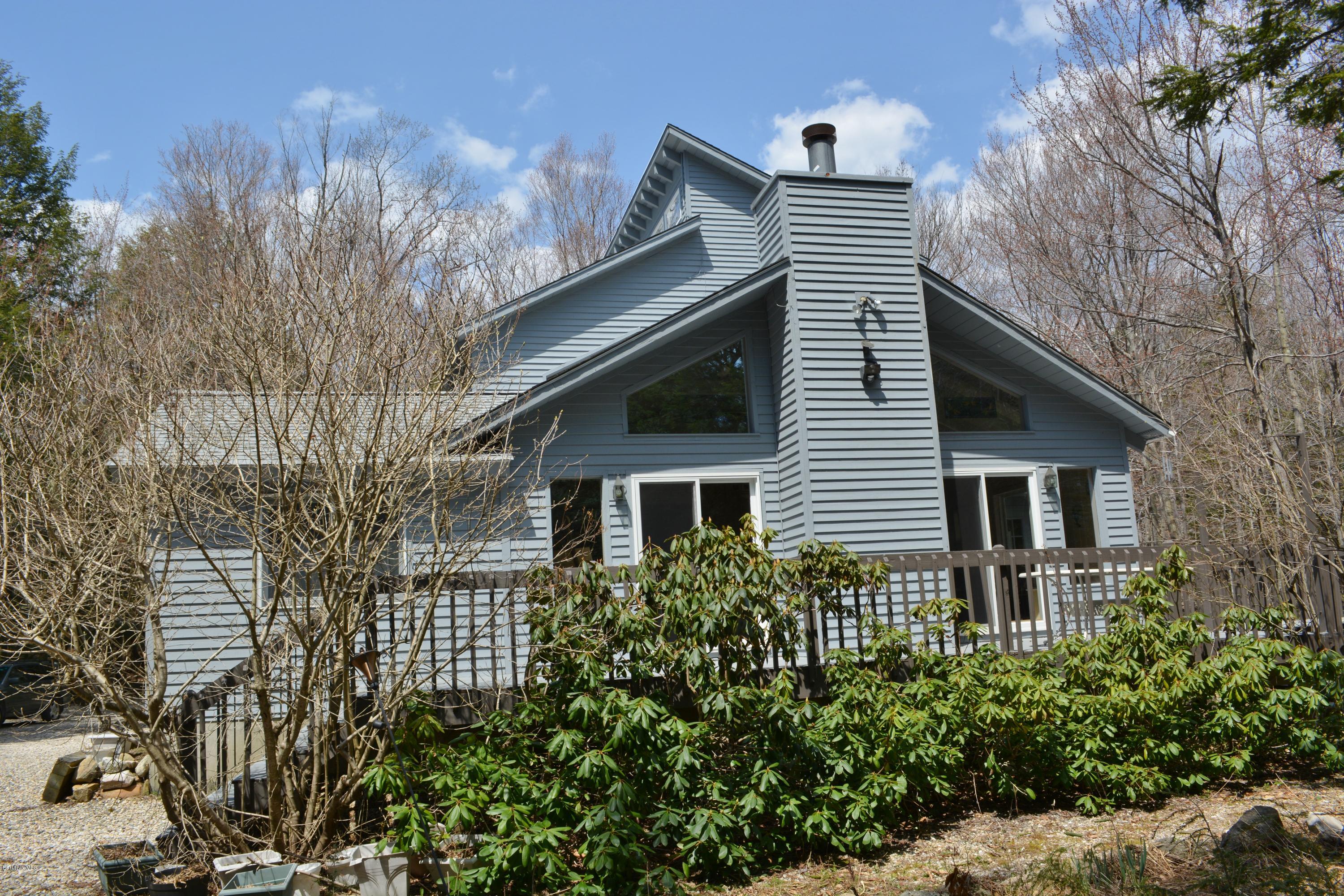 7 Sioux Road Becket, MA 01223 - Photo 13 of 22 a front view of a house with a yard and potted plants
