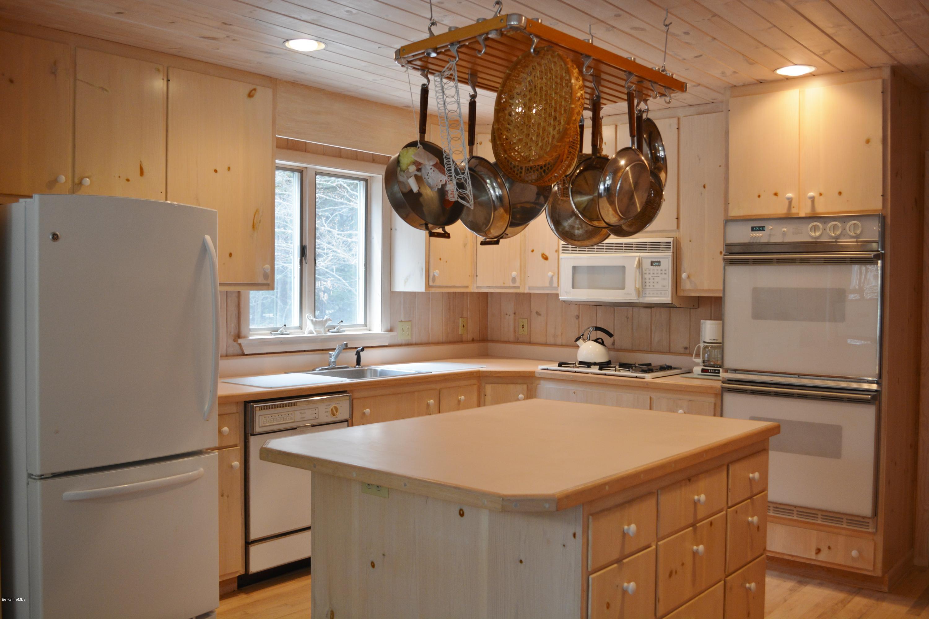 7 Sioux Road Becket, MA 01223 - Photo 5 of 22 a kitchen with stainless steel appliances granite countertop a sink a stove and a refrigerator