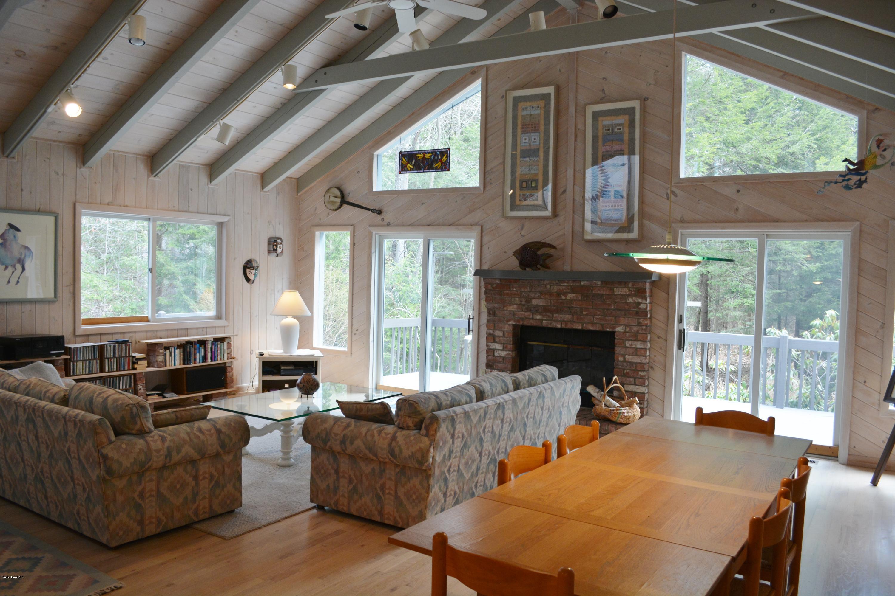 7 Sioux Road Becket, MA 01223 - Photo 6 of 22 a living room with furniture a large window and a fireplace