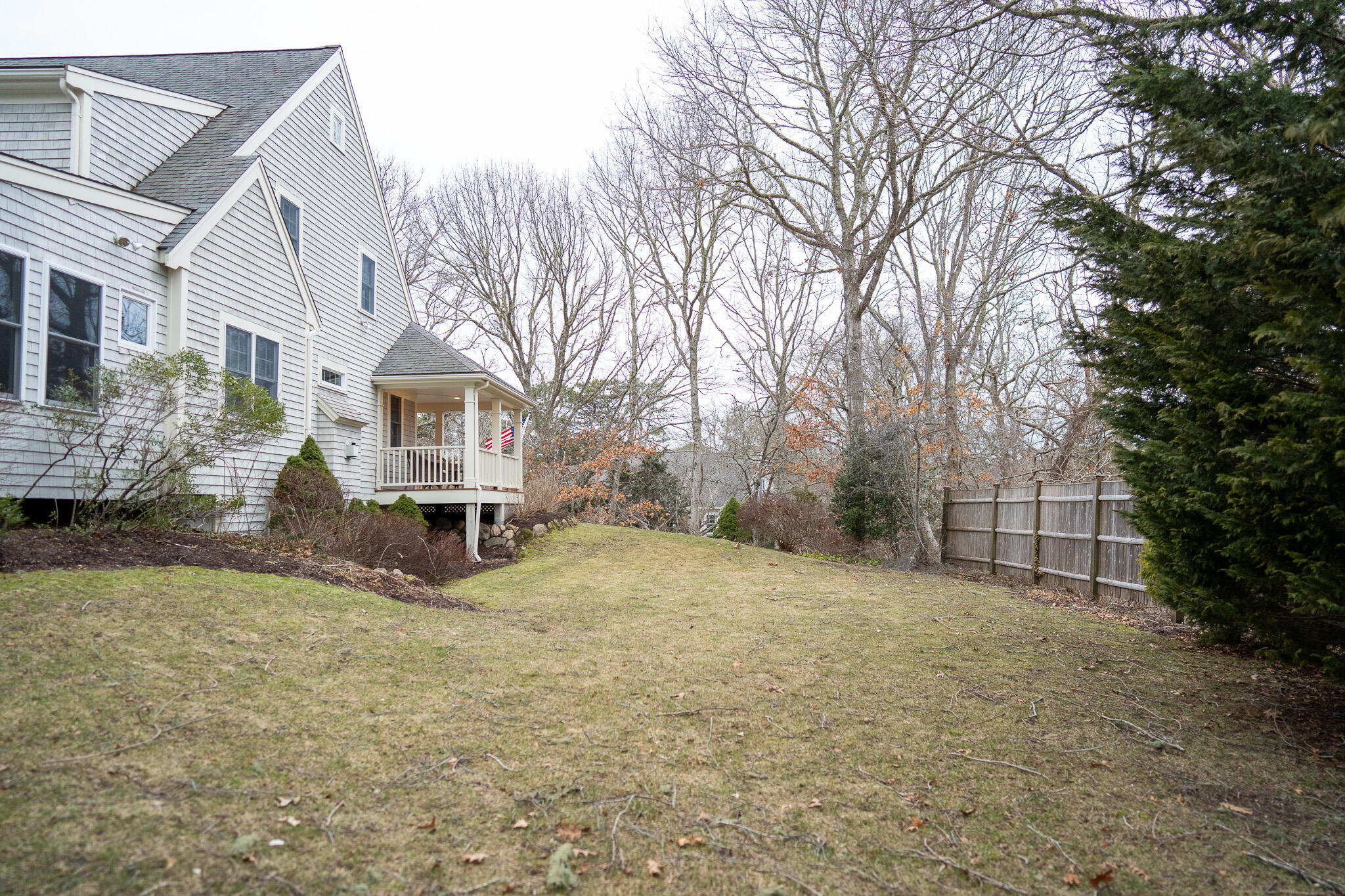 10 Abbey Gate Road Cotuit, MA 02635 - Photo 65 of 67 a view of a house with a yard covered in snow