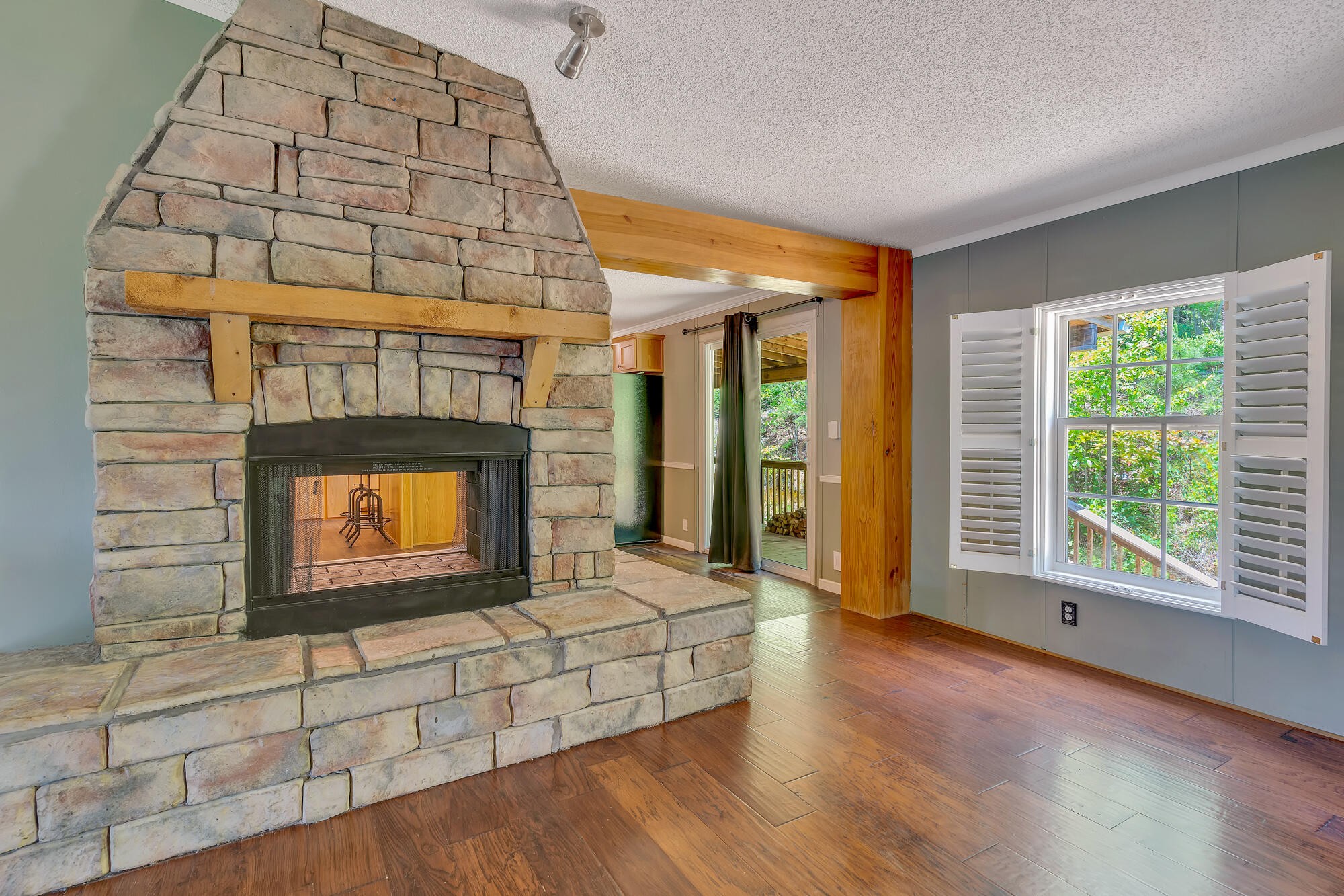 1012 Red Clay Road Cleveland, TN 37311 - Photo 8 of 31 a living room with fireplace furniture and a floor to ceiling window