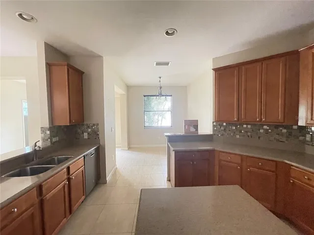 a kitchen with granite countertop a sink and cabinets
