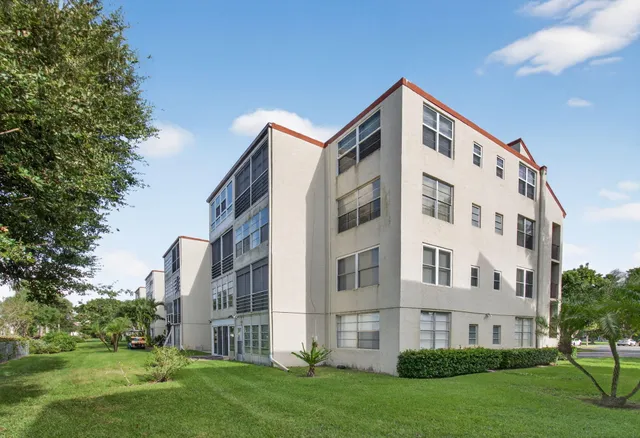 a front view of a building with garden
