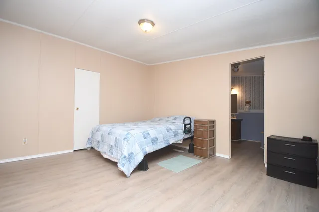 a bedroom with a bed and a dresser