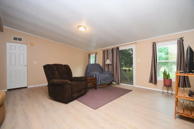 a living room with furniture and a large window