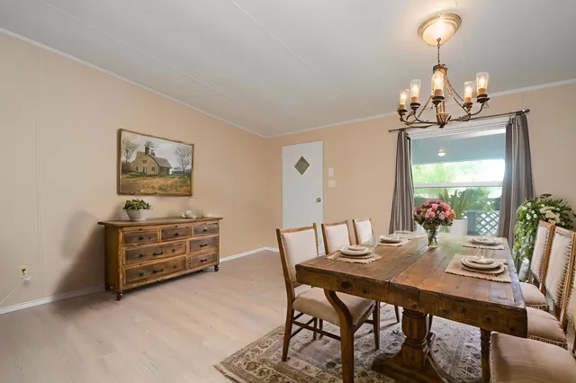 a view of a dining room with furniture and chandelier