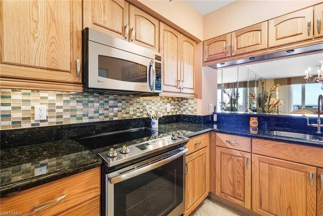 a kitchen with stainless steel appliances granite countertop a sink and cabinets