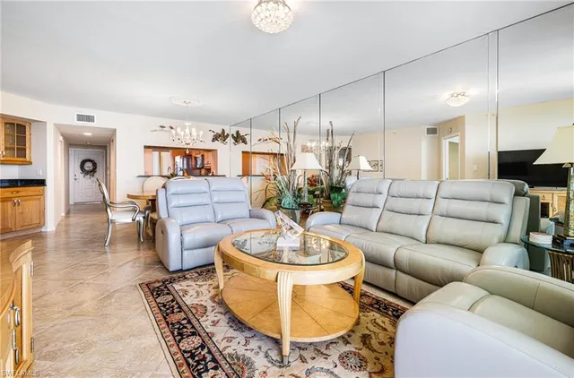 a living room with furniture a rug and a large window
