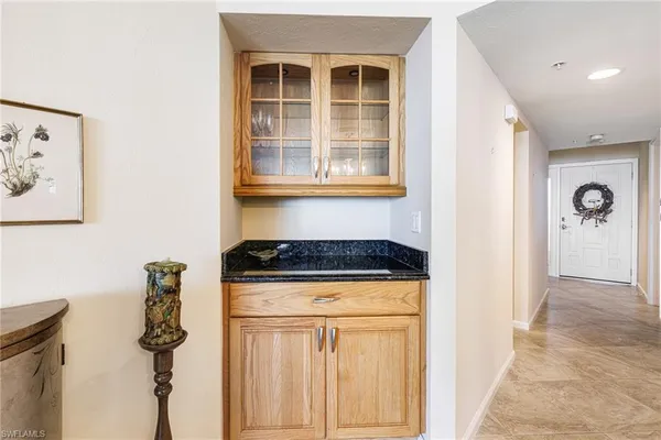 a kitchen with granite countertop a stove microwave and refrigerator