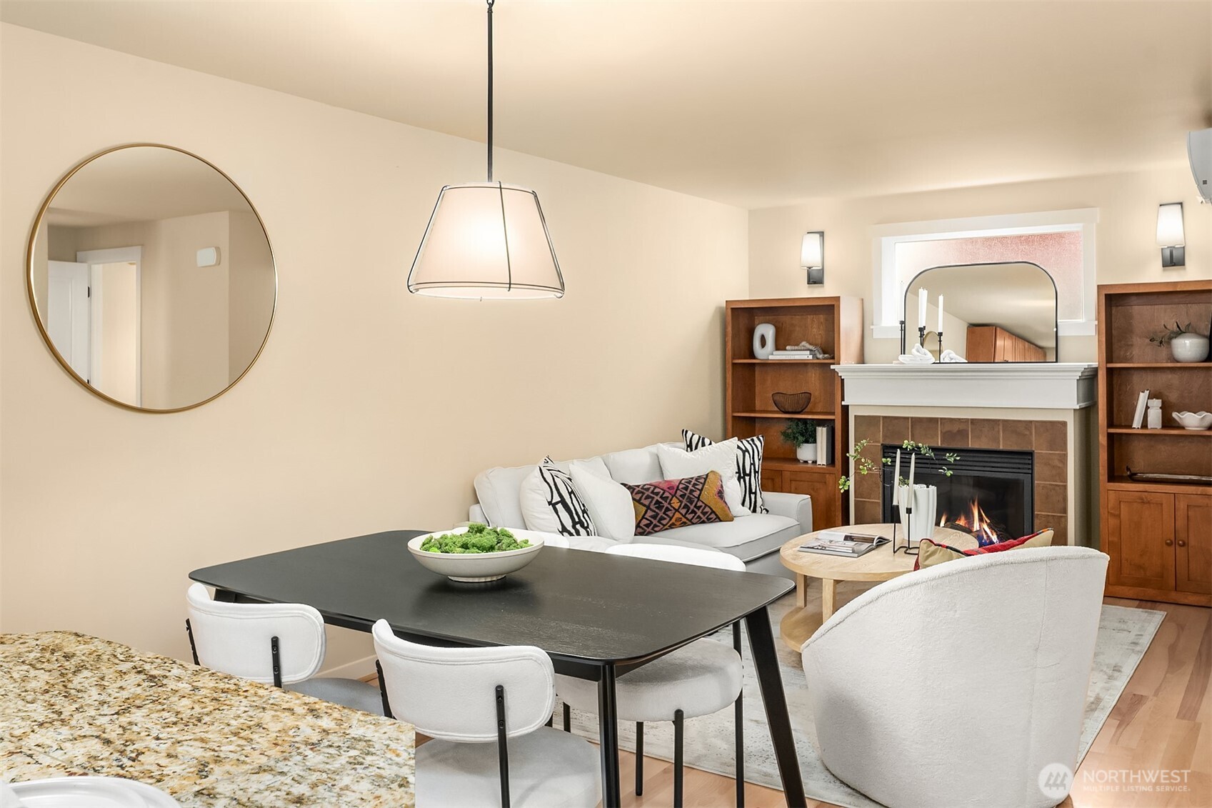 3615 Albion Place North, Unit B Seattle, WA 98103 - Photo 7 of 30 a living room with furniture a fireplace and a chandelier