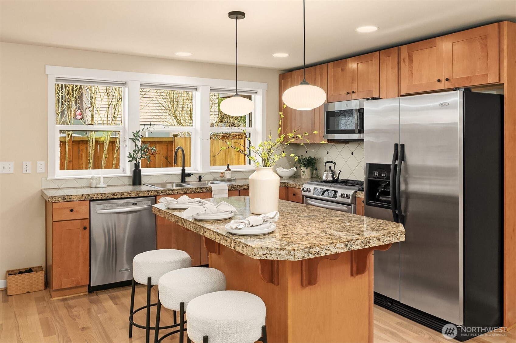 3615 Albion Place North, Unit B Seattle, WA 98103 - Photo 9 of 30 a kitchen with stainless steel appliances granite countertop a sink a stove a refrigerator cabinets and dining table