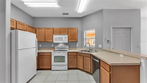 a kitchen with a stove a sink and a refrigerator