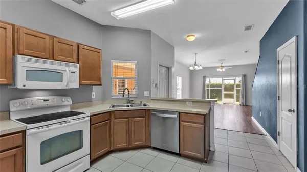 a kitchen with a sink stove and microwave