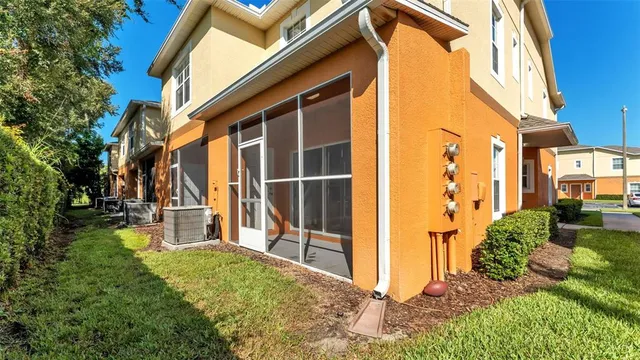a view of a house with backyard and sitting area