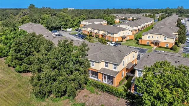 an aerial view of residential houses with outdoor space and street view
