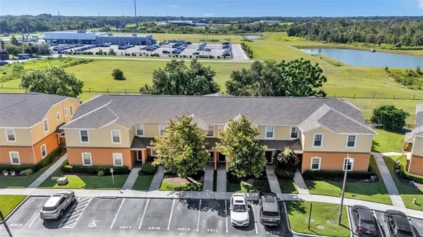 an aerial view of a house with swimming pool and mountains