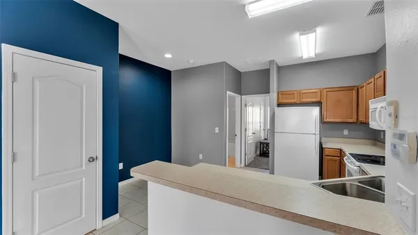 a kitchen with stainless steel appliances a refrigerator and a cabinets