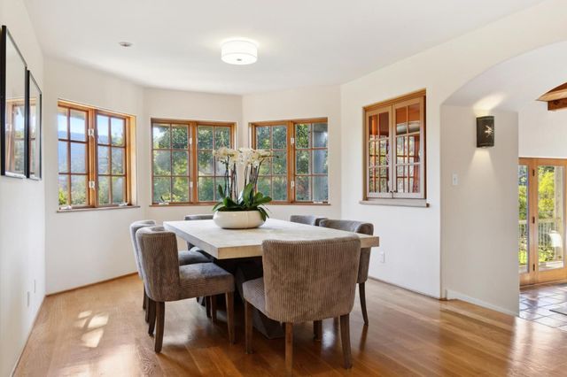 a view of a dining room with furniture window and wooden floor
