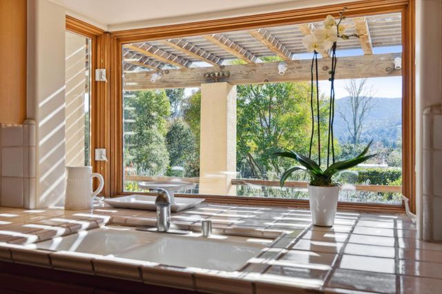 a view of a living room with a floor to ceiling window and floor to ceiling window