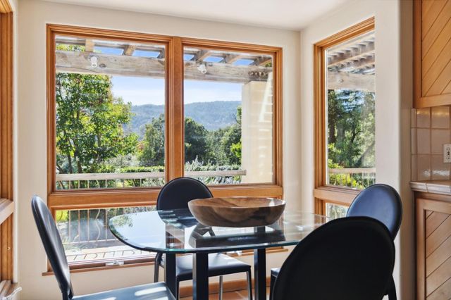 a dining room with furniture and a window
