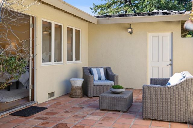 a stairs and a couch in front of a door