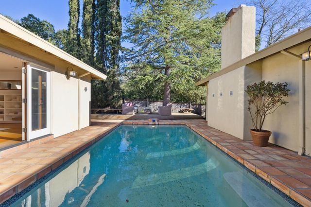 a view of backyard with swimming pool