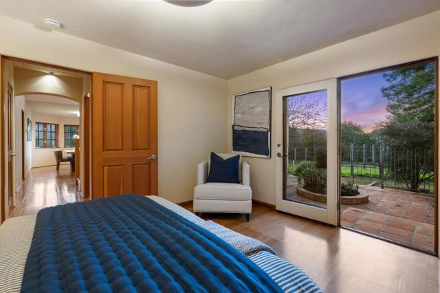 a bedroom with a bed and glass door