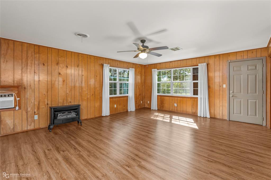 104 3rd Street Northwest Springhill, LA 71075 - Photo 13 of 28 a view of an empty room with a window and wooden floor