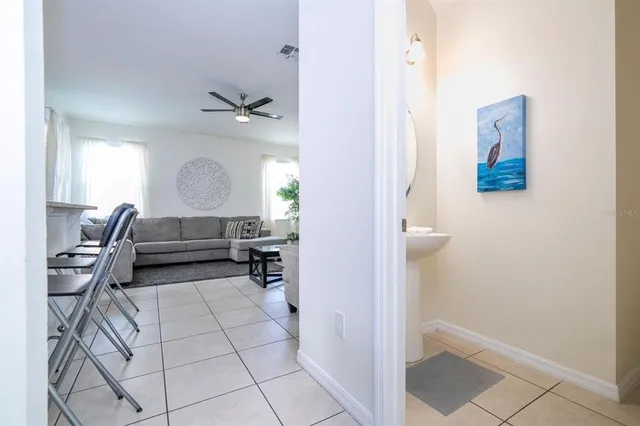 a view of hall way with furniture and wooden floor