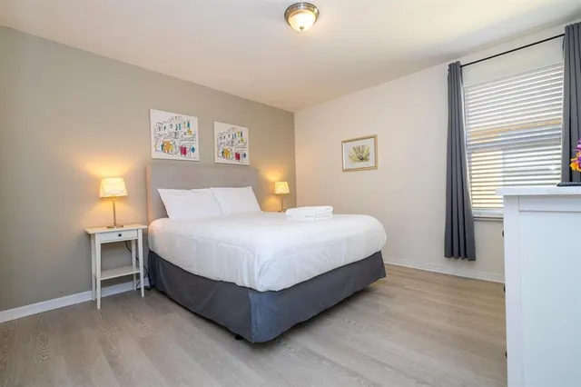 a bedroom with a bed and a night stand