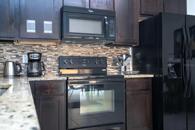 a kitchen with a stove and a microwave