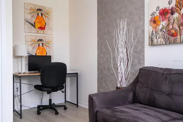 a living room with furniture and a workspace