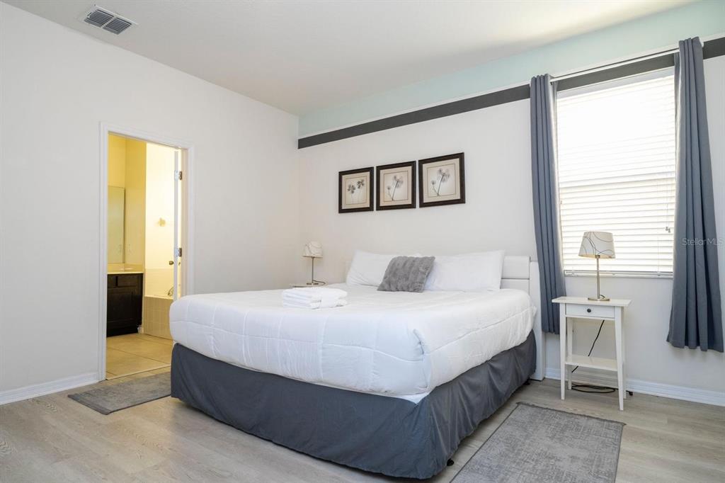 2625 Santosh Cove Kissimmee, FL 34746 - Photo 17 of 29 a bedroom with a bed and a night stand