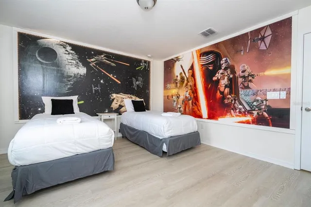 a bedroom with a large bed and a large window with outer view