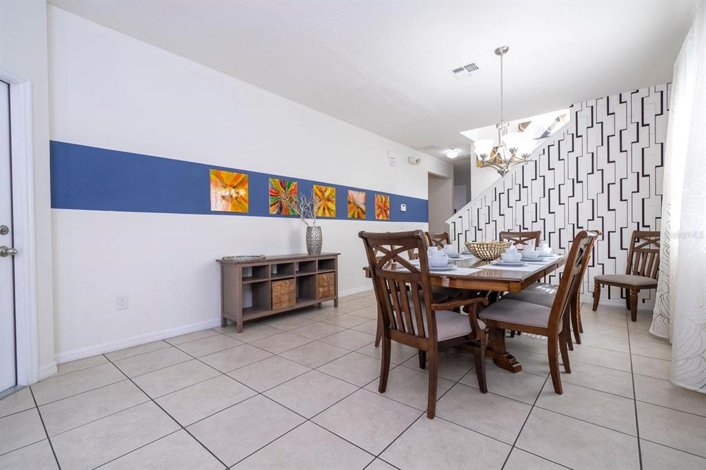 2625 Santosh Cove Kissimmee, FL 34746 - Photo 3 of 29 a view of a dining room with furniture